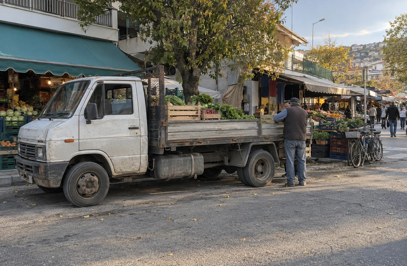 Local workers loading farm produce onto a diesel delivery truck at a market